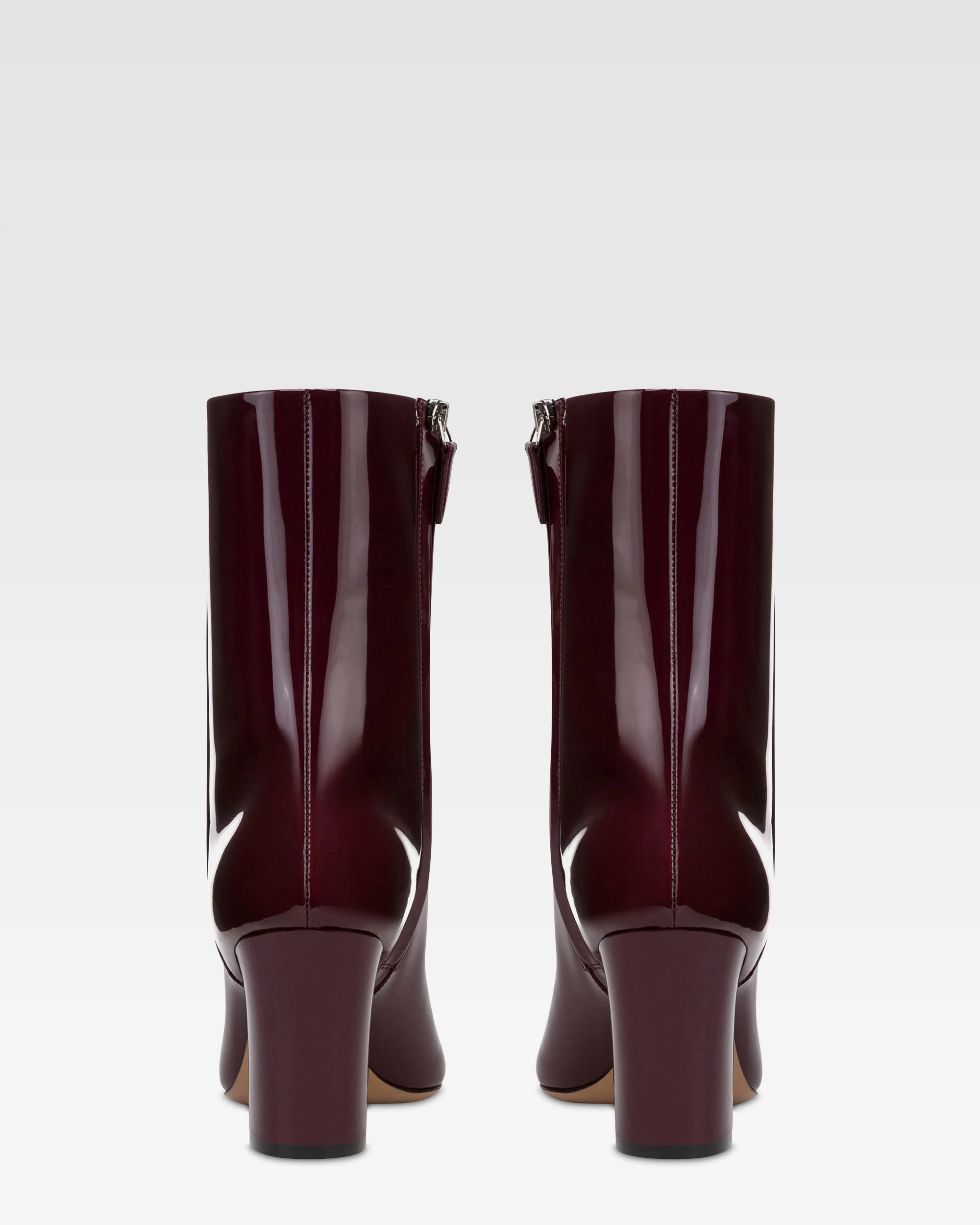 Ankle boots in rouge noir patent leather. 4 Ankle boots in rouge noir patent leather.