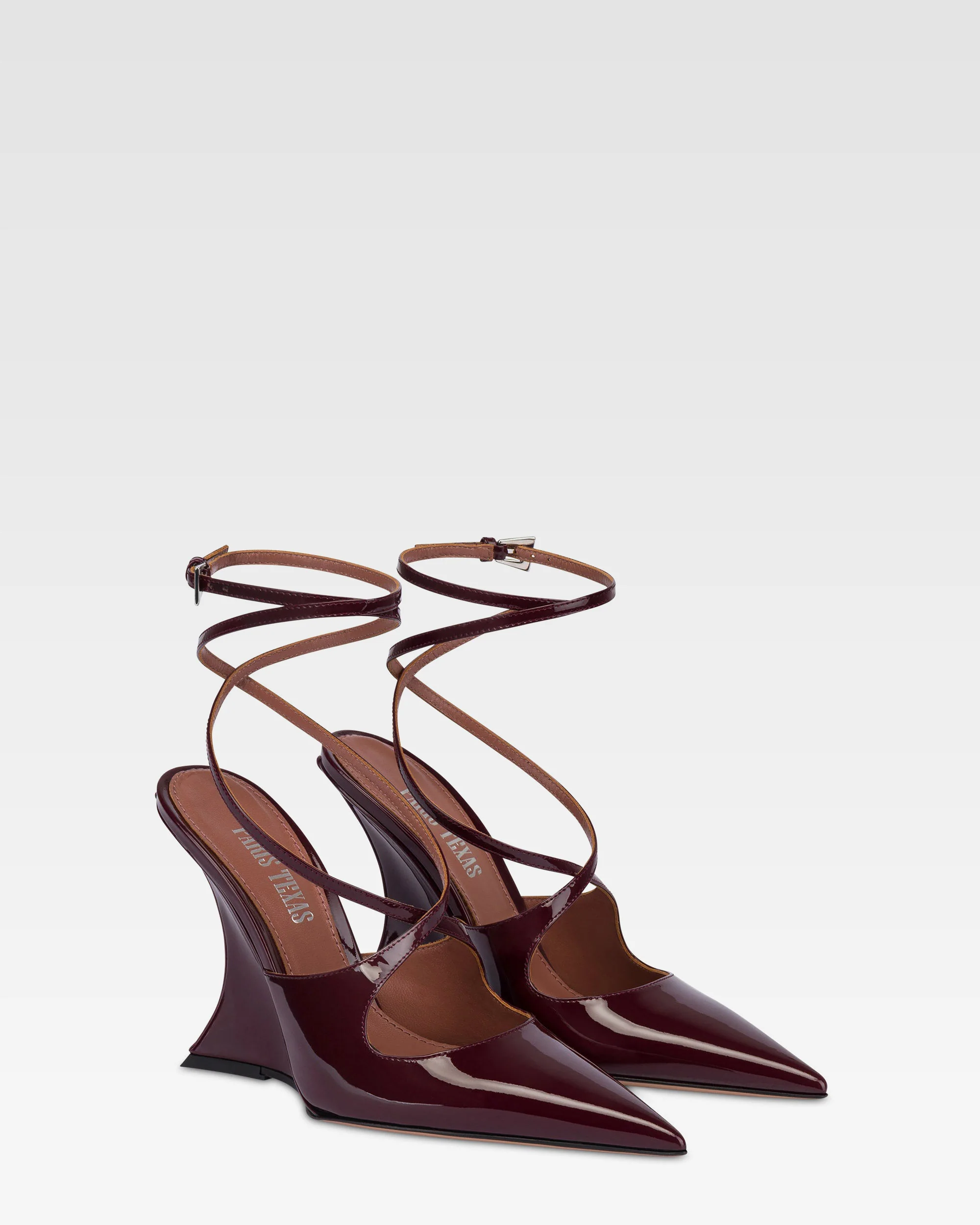 Ankle-strap pumps in rouge noir patent leather.