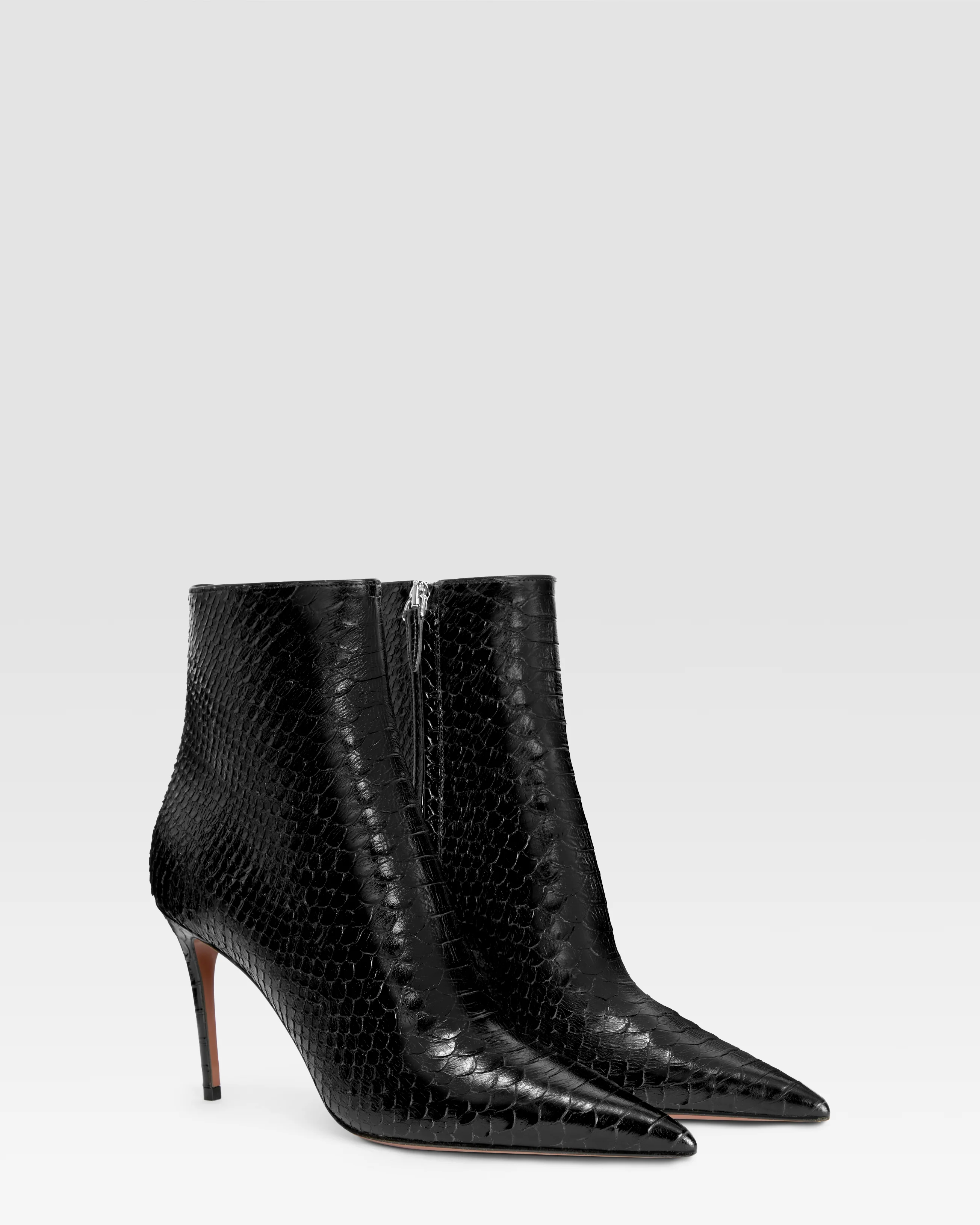 Ankle boots in black printed python leather