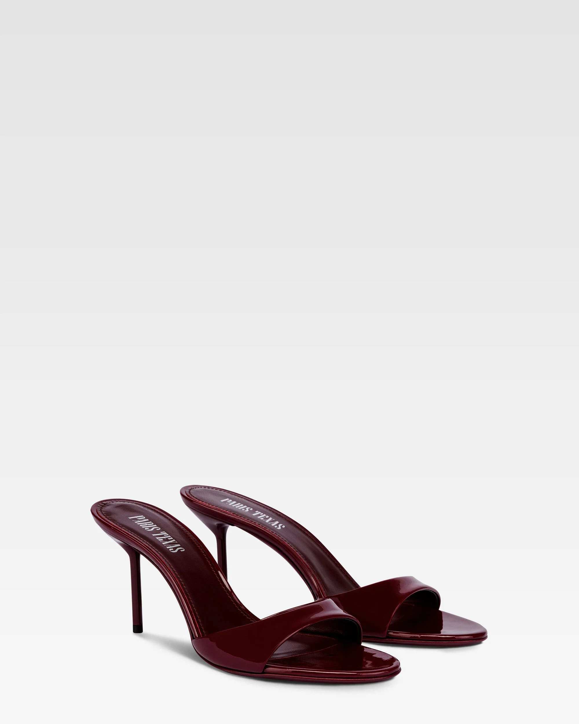 Almond-toe mules in patent rouge noir leather